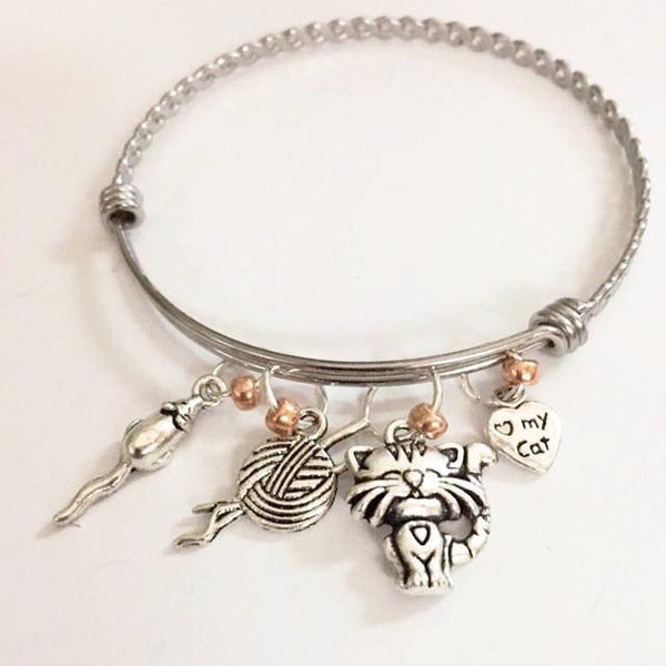 Charm bracelet; loves her cat theme/"Henri"