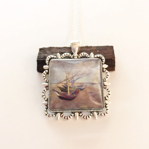 watercolor painting on a pendant/three boats on the shore