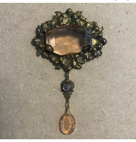 Exquisite glass and ornate metal brooch