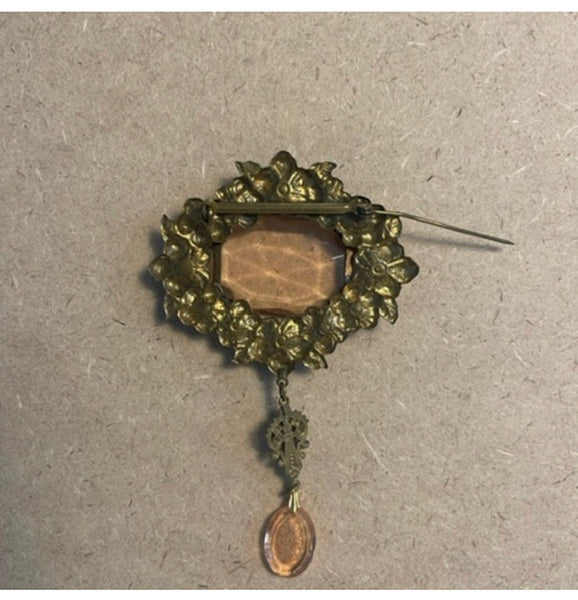 Exquisite glass and ornate metal brooch